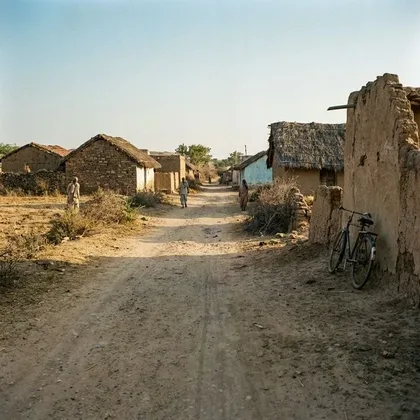 An empty dusty road in a remote village with no clinic in sight